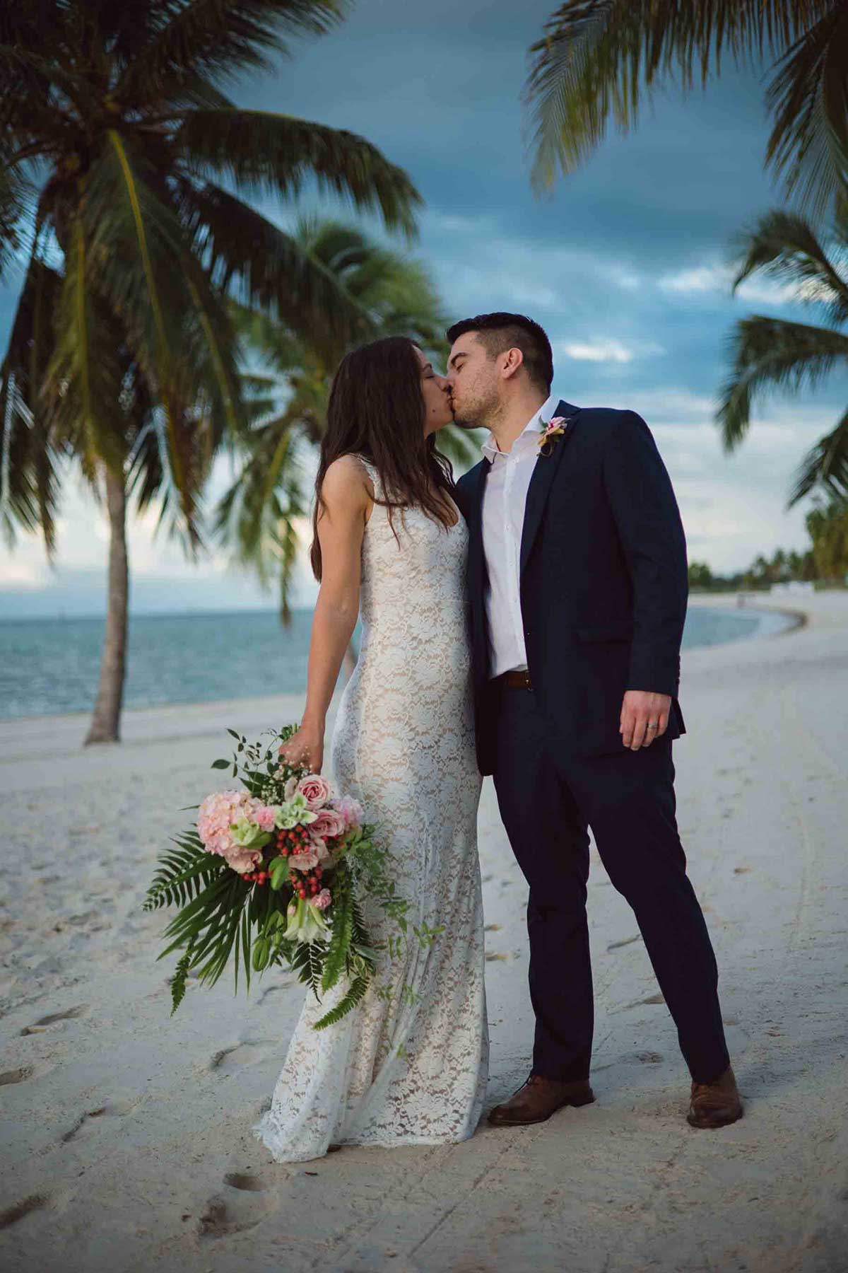 A newlywed couple at Smather's beach in Key West