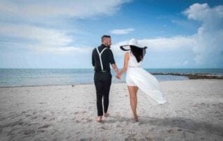 Keywords used: key west wedding photographer, key west weddingDescription: A beautiful key west wedding captured by a talented photographer. The bride and groom are seen holding hands on the serene beach, with the