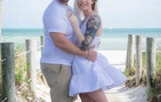 A couple posing on a wooden boardwalk on the beach, captured beautifully by a talented Key West wedding photographer.