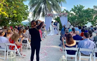 A beach wedding ceremony in Key West with a professional photographer capturing memorable moments.