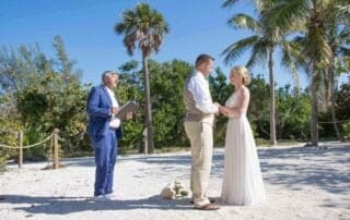 A bride and groom exchange vows on the beach with the expertise of a key west wedding officiant.