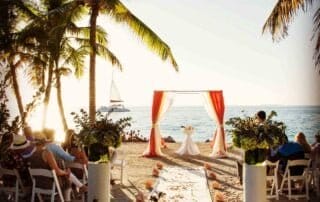 A picturesque beach wedding ceremony with chairs and umbrellas, captured beautifully by a talented Key West wedding photographer.