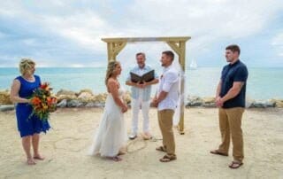 A romantic beach wedding ceremony in Key West with a stunning bride and handsome groom.