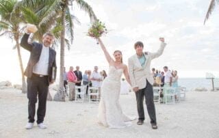 A bride and groom celebrating their key west wedding on the beach.