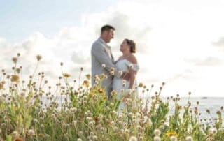A stunning bride and groom exchange vows in a picturesque field of wildflowers, captured beautifully by a talented Key West wedding photographer.
