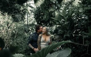 A bride and groom embrace in a tropical garden at their Key West wedding.