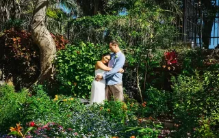 A bride and groom embracing in a tropical garden captured by a talented key west wedding photographer.