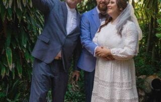 A bride and groom capturing an unforgettable selfie amidst the beauty of a garden, with the assistance of a talented key west wedding photographer.