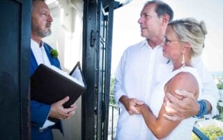 A man and woman are getting married on a beautiful balcony in Key West, captured by a talented Key West wedding photographer.