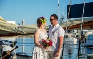 A picturesque key west wedding captured by a talented photographer on the bow of a sailboat.