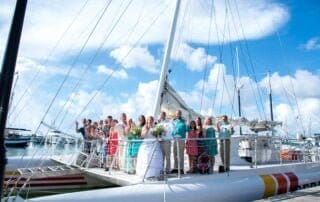 A group of people standing on the top of a boat during a Key West wedding ceremony.