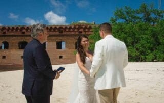 A couple celebrates their romantic beach wedding in Key West with the assistance of a professional officiant and photographer capturing their special moments.