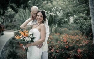 A bride and groom embracing in a picturesque garden captured by a talented key west wedding photographer.