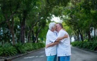 An older couple hugging in the middle of a street during their Key West wedding.