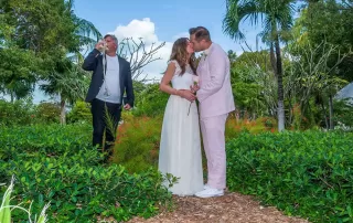 A bride and groom sharing a passionate kiss in a picturesque garden, captured beautifully by a talented Key West wedding photographer.