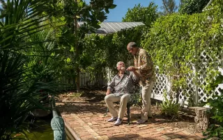 A couple sitting on a bench next to a scenic pond, capturing moments with a key west wedding photographer.