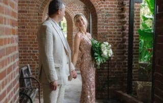 A bride and groom standing in an archway, captured beautifully by a talented Key West wedding photographer.