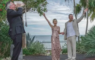 A man and woman in a wedding dress standing in front of a palm tree, captured by a Key West wedding photographer.