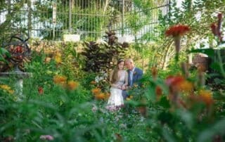 Key West wedding photographers capture a beautiful moment of a bride and groom posing in a garden.
