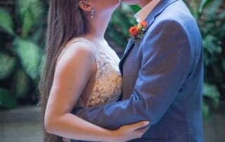 A bride and groom sharing a romantic kiss in a beautiful courtyard during their Key West wedding.