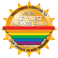 Logo of the key west business guild featuring a rainbow stripe design and a starburst badge, labeled "welcoming everyone to our unique island paradise since 1978.